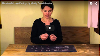 Instructional video thumbnail showing the jeweler LothLorien Stewart demonstrating how to put on Mostly Sweet Jewelry's hoop earrings with the secure endless clasp design