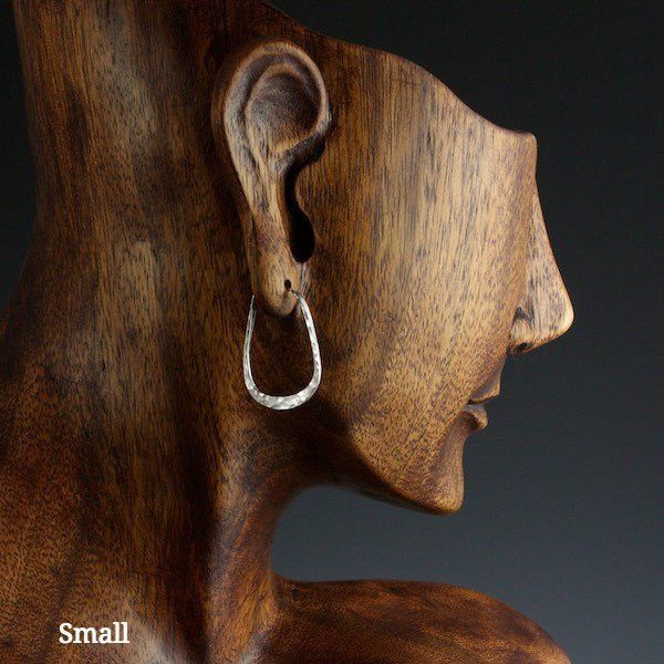 Small sterling silver elliptical hoop earrings on model